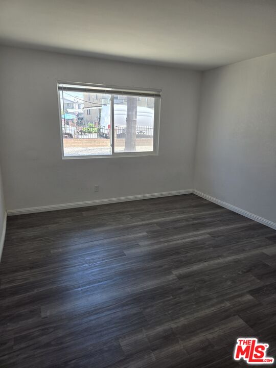 2417 South Budlong Avenue, Unit U#1 R#1 Los Angeles, CA 90007 - Photo 5 of 6 a view of an empty room with wooden floor and a window