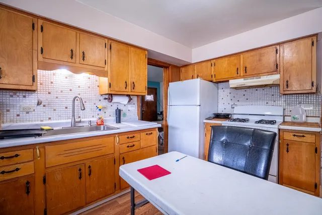 a kitchen with a sink stove and refrigerator