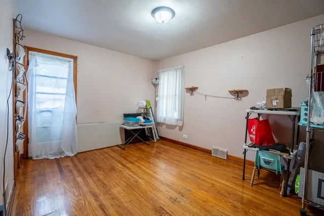 a view of a workspace with furniture and wooden floor