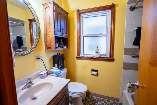a bathroom with a sink toilet and mirror