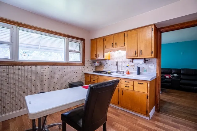a kitchen with granite countertop a sink cabinets and window