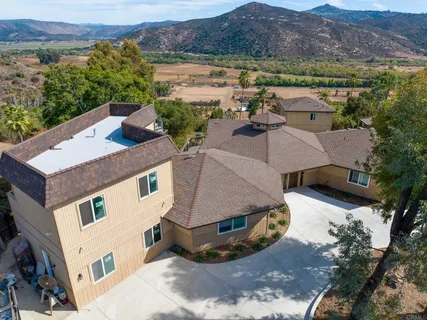 an aerial view of a house with a yard and garden