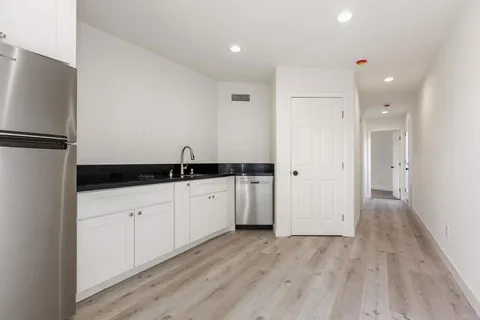 a kitchen with stainless steel appliances a refrigerator and a sink