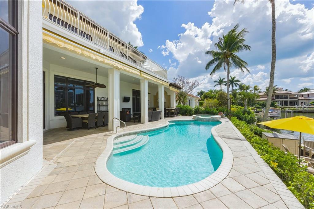 361 Pirates Bight Naples, FL 34103 - Photo 41 of 45 a view of a swimming pool with a lounge chair