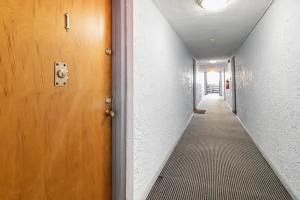 a view of a hallway with wooden floor
