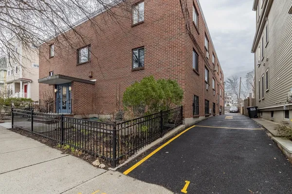 a view of a street with brick wall