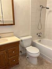 908 Cross Bend Road Plano, TX 75023 - Photo 7 of 11 a bathroom with a toilet a sink and bathtub