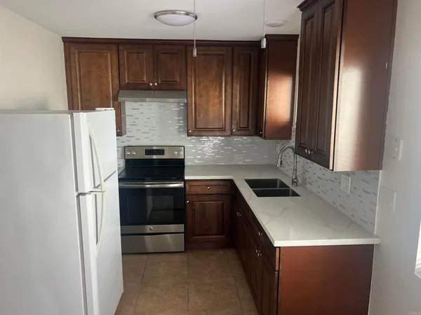 a kitchen with a stove and a refrigerator
