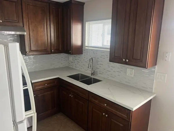 a kitchen with a sink cabinets and window