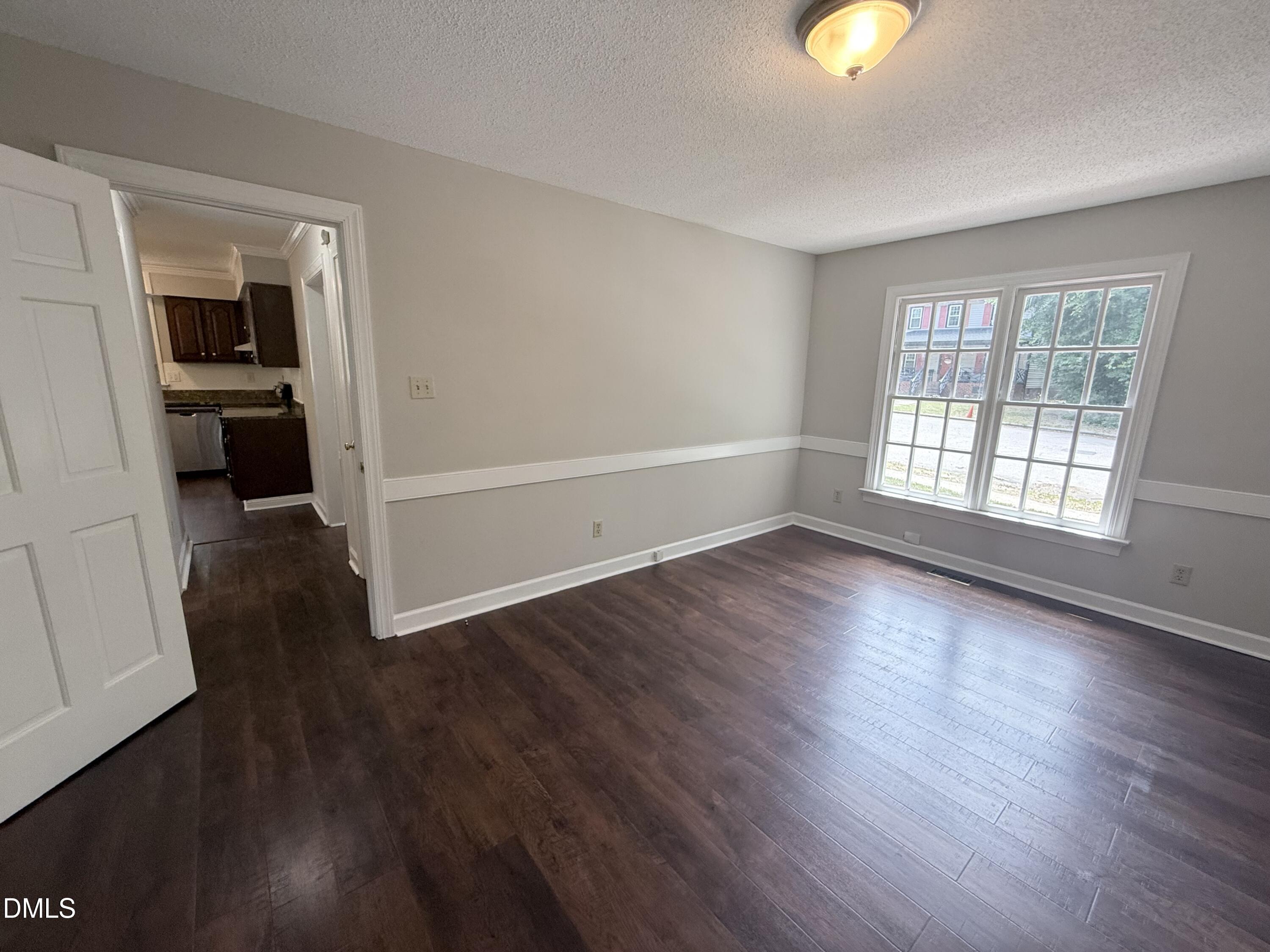2900 Broadlands Drive Raleigh, NC 27604 - Photo 37 of 60 an empty room with wooden floor and windows