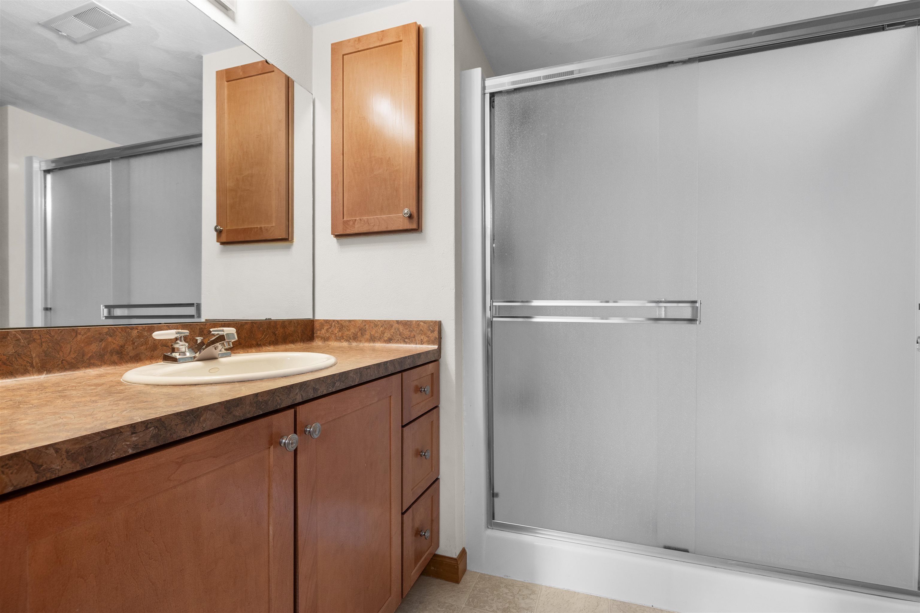 8317 Snaresbrook Road Roscoe, IL 61073 - Photo 32 of 45 a bathroom with a sink and a mirror