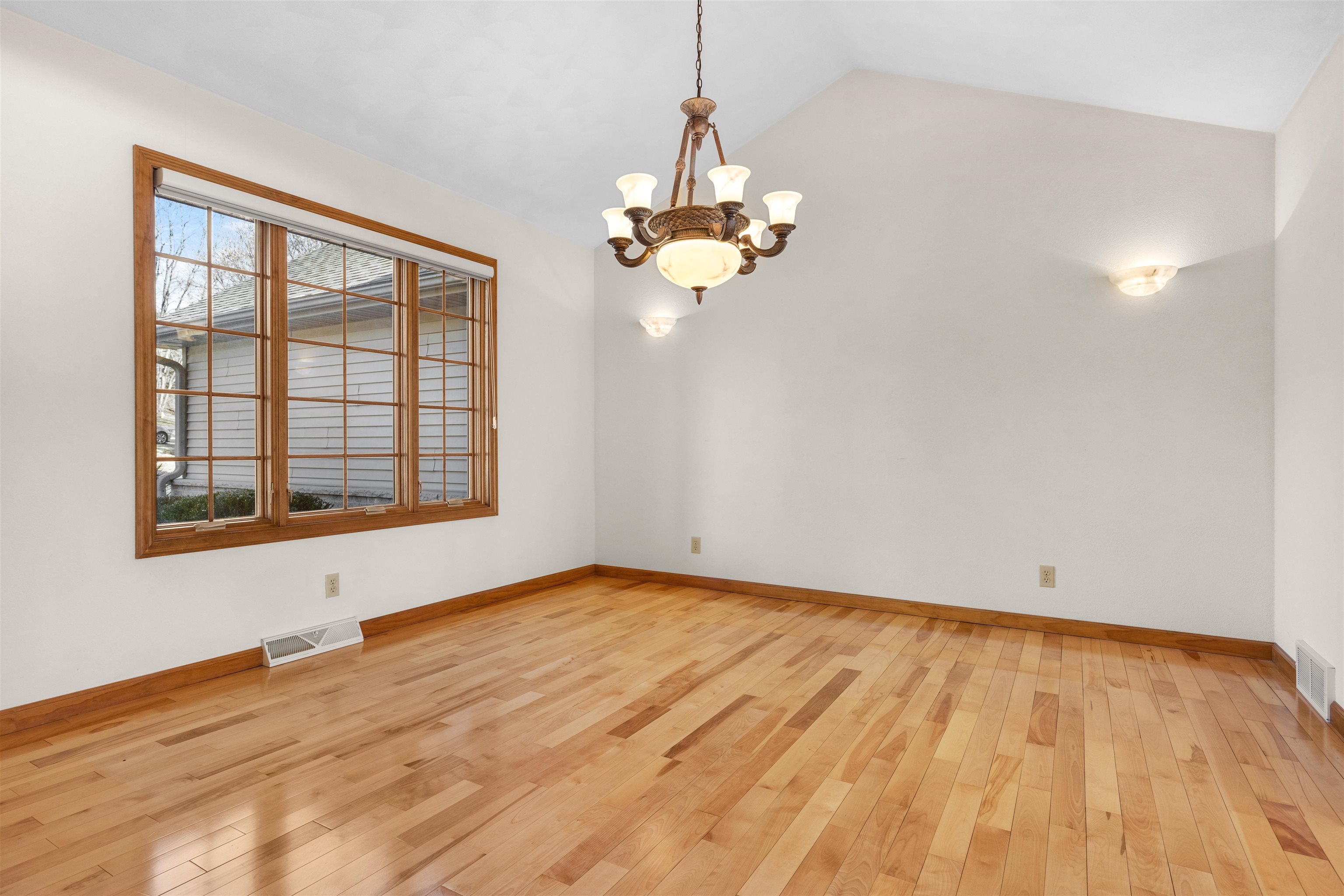 8317 Snaresbrook Road Roscoe, IL 61073 - Photo 4 of 45 a view of an empty room with wooden floor and a window