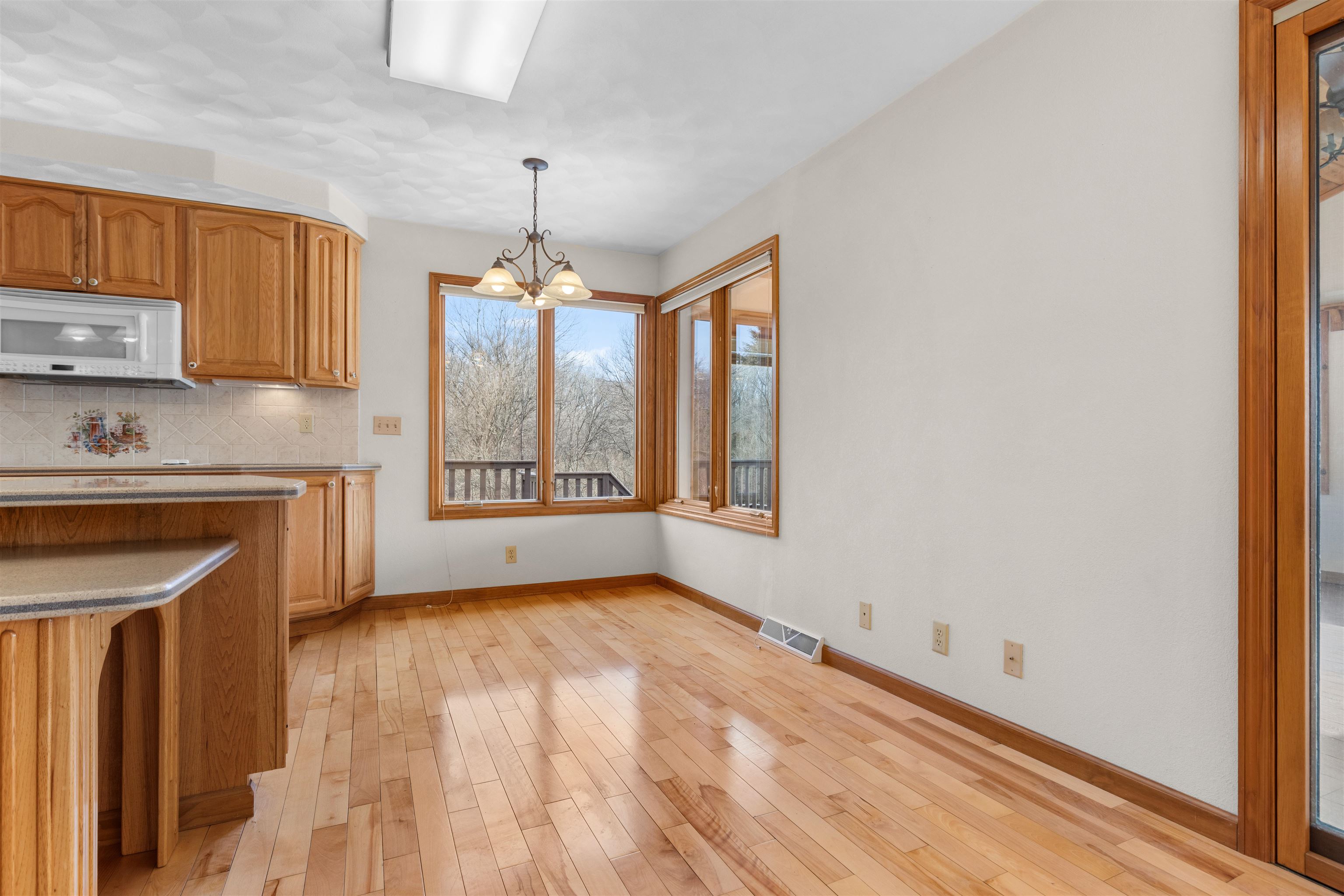 8317 Snaresbrook Road Roscoe, IL 61073 - Photo 9 of 45 a view of an empty room with a window and a kitchen