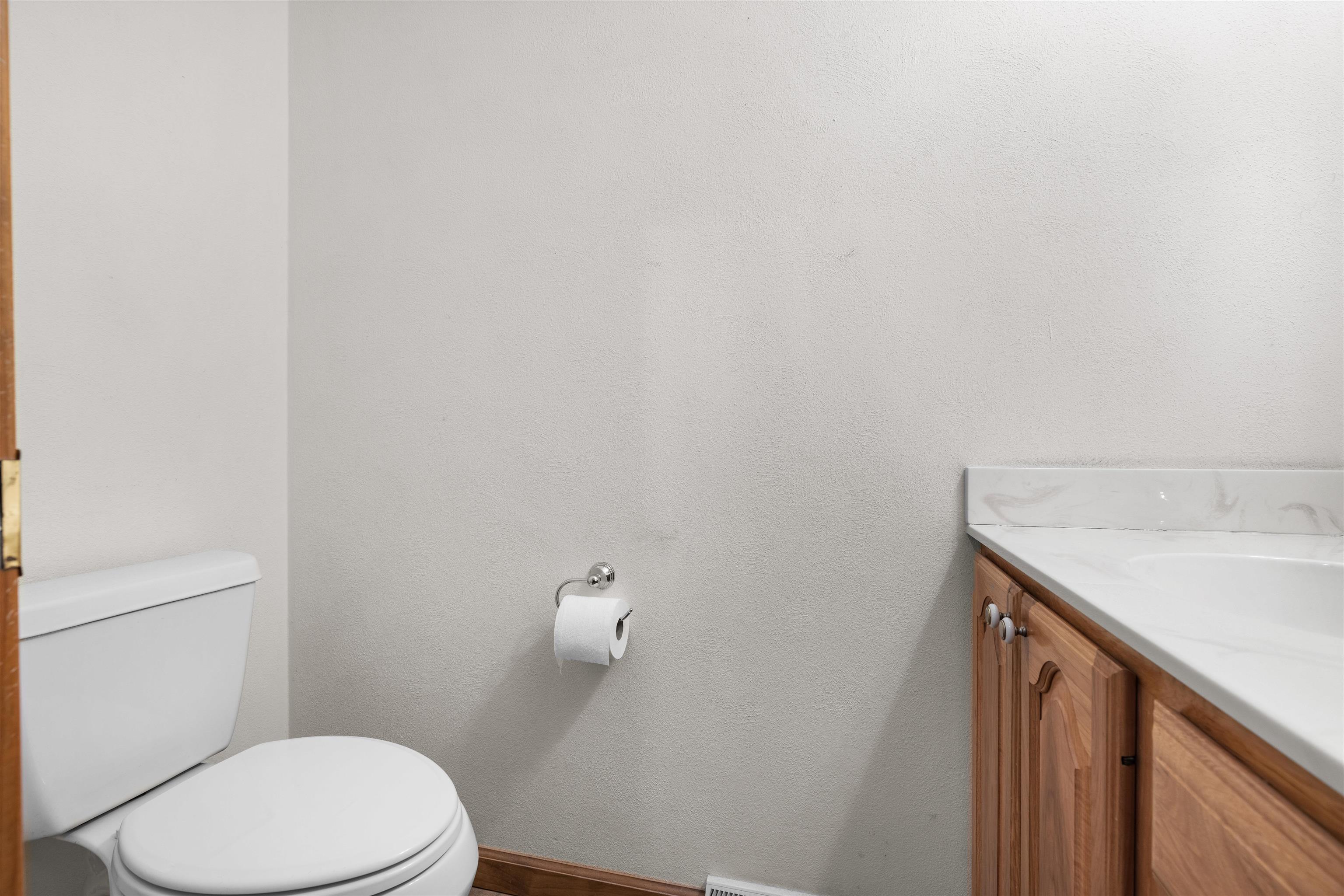 8317 Snaresbrook Road Roscoe, IL 61073 - Photo 10 of 45 a bathroom with a sink a toilet and vanity