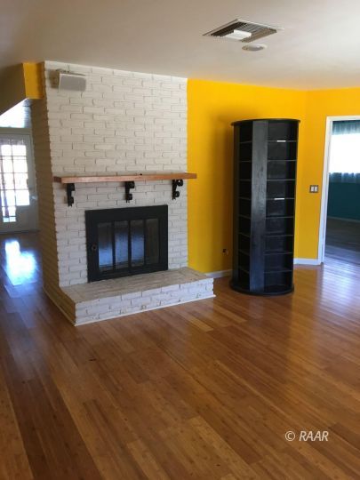 224 West Rader Avenue Ridgecrest, CA 93555 - Photo 3 of 26 a view of an empty room with wooden floor and a fireplace