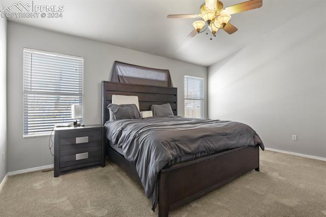 8036 Ferguson Road Peyton, CO 80831 - Photo 12 of 29 Bedroom with vaulted ceiling, ceiling fan, and carpet flooring