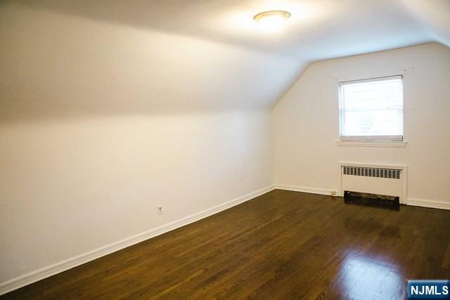 134 Berkshire Road Hasbrouck Heights, NJ 07604 - Photo 11 of 17 an empty room with wooden floor and windows