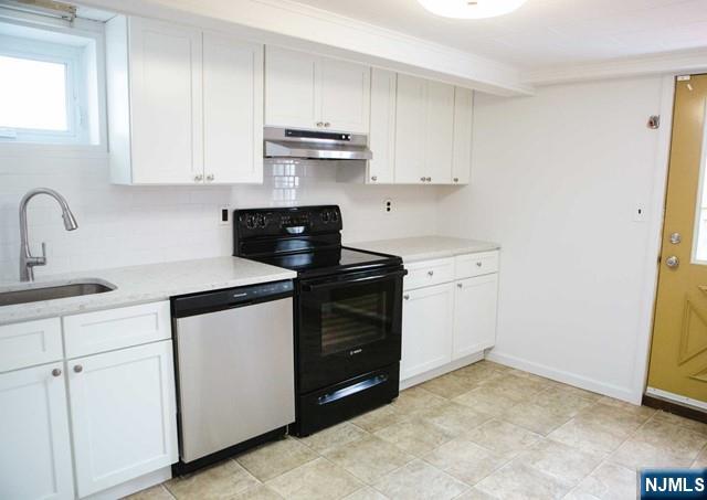 134 Berkshire Road Hasbrouck Heights, NJ 07604 - Photo 13 of 17 a kitchen with white cabinets and appliances