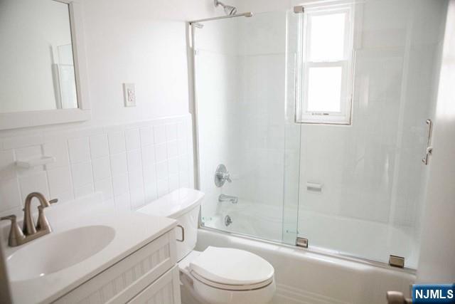 134 Berkshire Road Hasbrouck Heights, NJ 07604 - Photo 15 of 17 a bathroom with a sink a toilet and shower