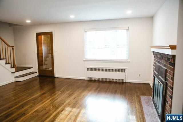 134 Berkshire Road Hasbrouck Heights, NJ 07604 - Photo 4 of 17 wooden floor in an empty room with a window