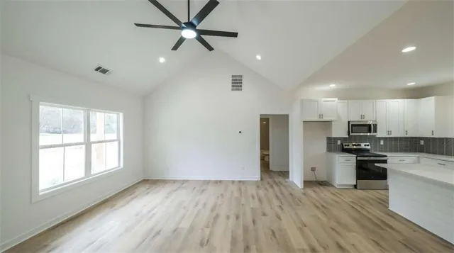 a view of a kitchen with a stove cabinets and wooden floor