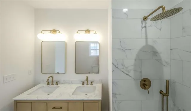 a bathroom with a granite countertop sink mirror and vanity