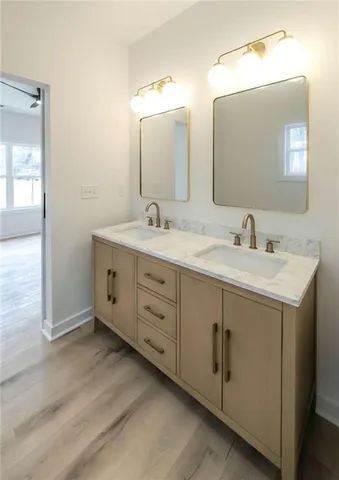 a bathroom with a double vanity sink and mirror