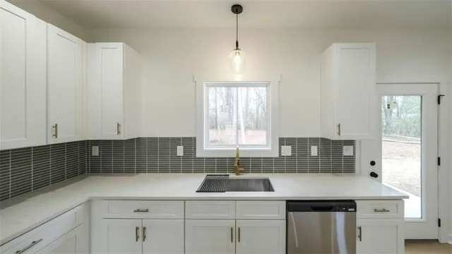 a kitchen with a sink and cabinets