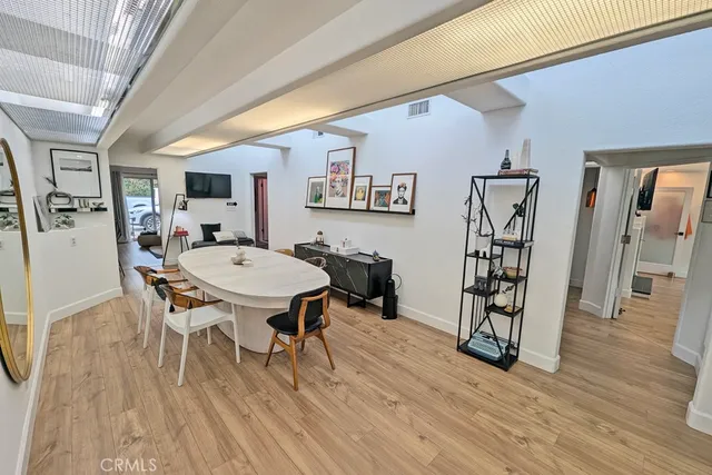 a dining room with furniture and wooden floor