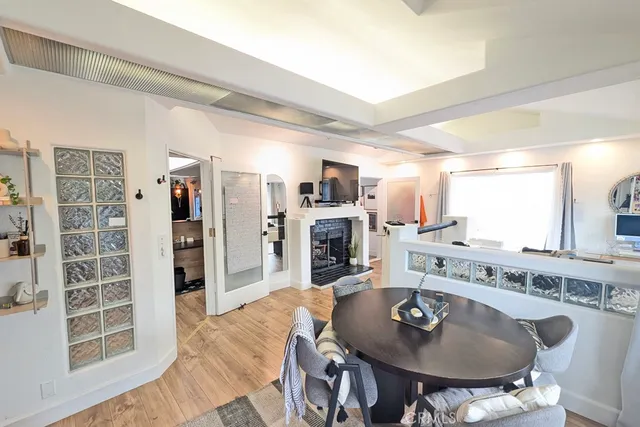 a dining room with furniture and wooden floor