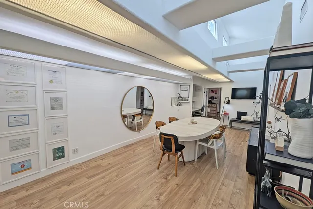 a living room with furniture a table and wooden floor