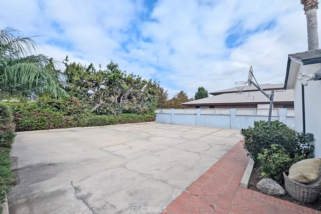 a aerial view of a house with a yard and potted plants