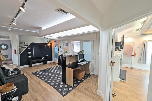 a view of a dining room with furniture large windows and wooden floor