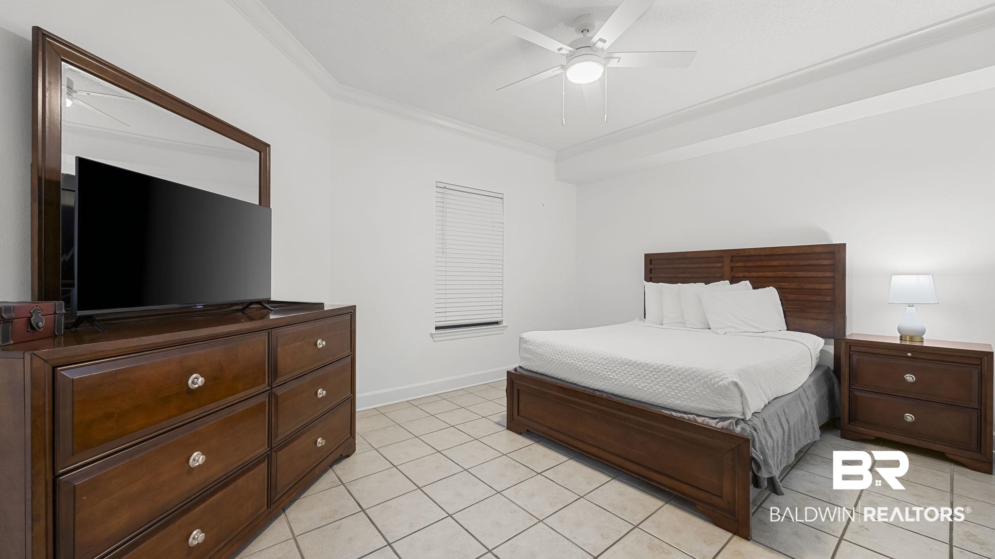 27580 Canal Road, Unit 1213 Orange Beach, AL 36561 - Photo 12 of 27 Spacious room featuring neutral tile flooring, crown molding, a window with horizontal blinds, and a ceiling fan with integrated lighting