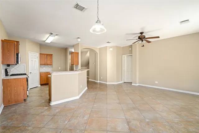 a view of a kitchen with a sink a refrigerator and a view of living room