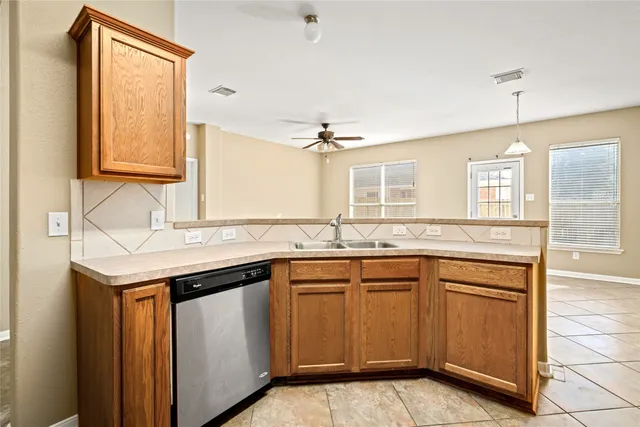 a kitchen with a sink stove and cabinets