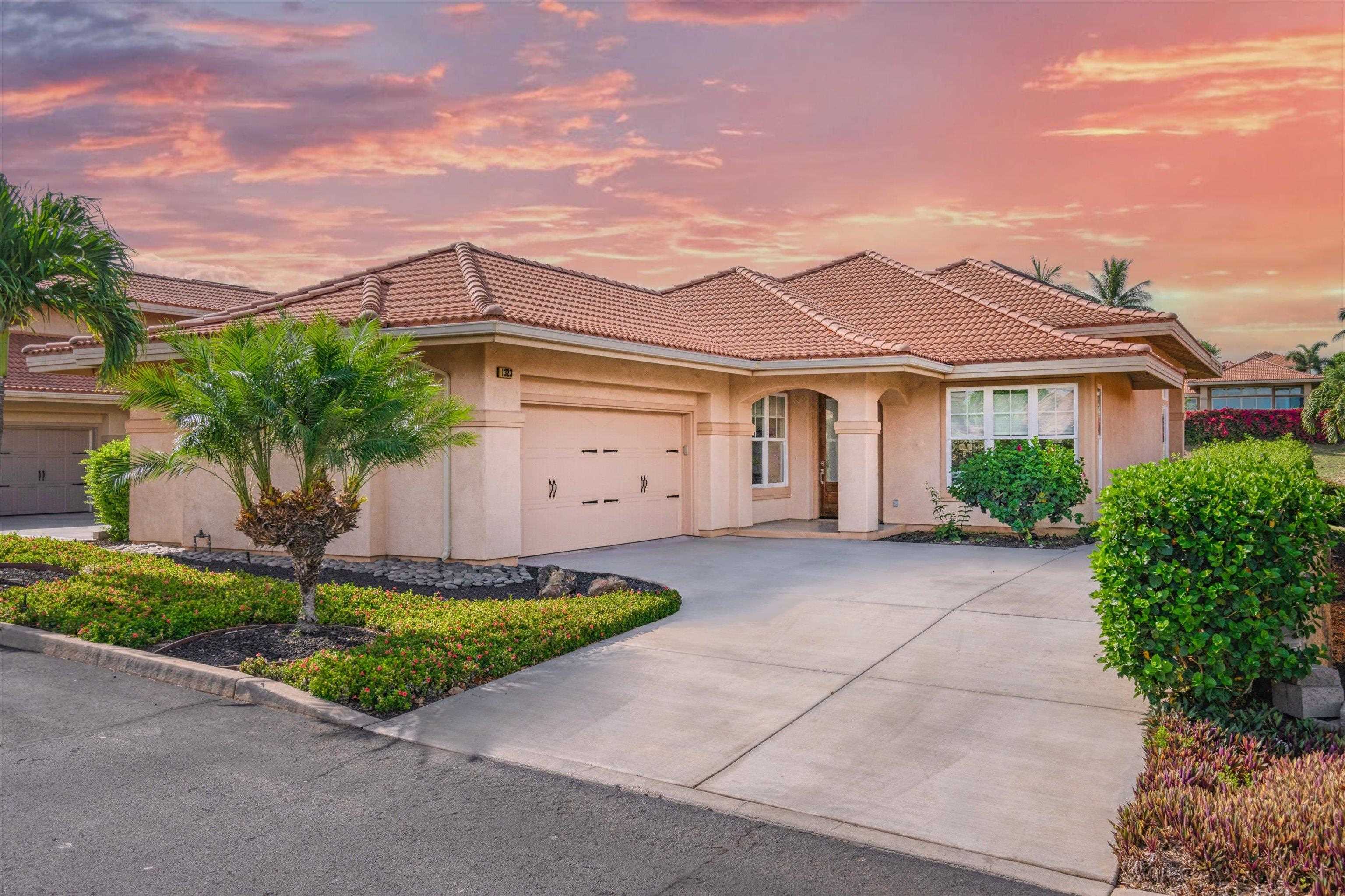 1323 Umeke Circle, Unit 102 Kihei, HI 96753 - Photo 1 of 50 a front view of a house with a yard and garage