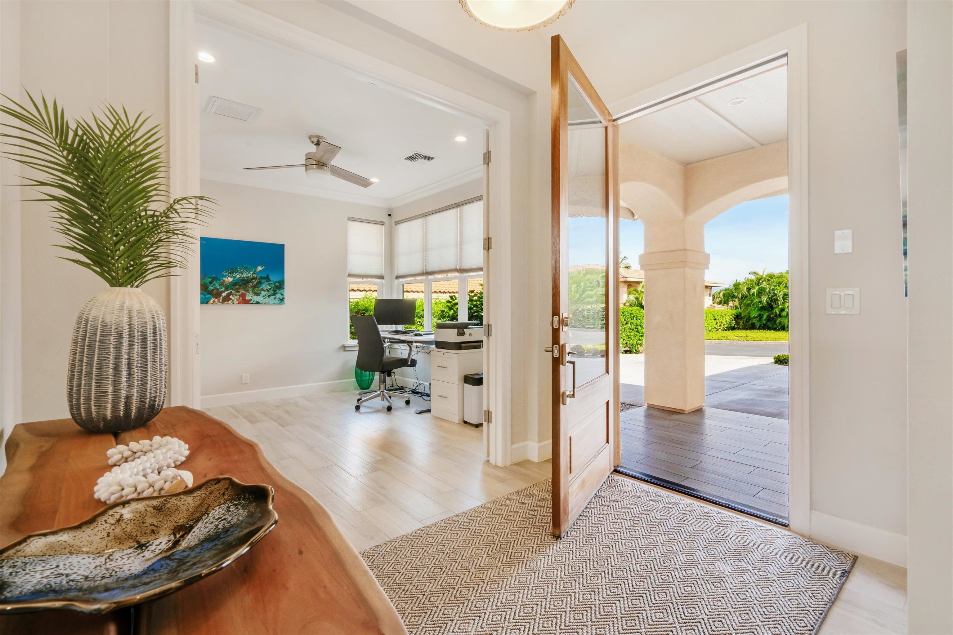 1323 Umeke Circle, Unit 102 Kihei, HI 96753 - Photo 16 of 50 a living room with furniture and a floor to ceiling window