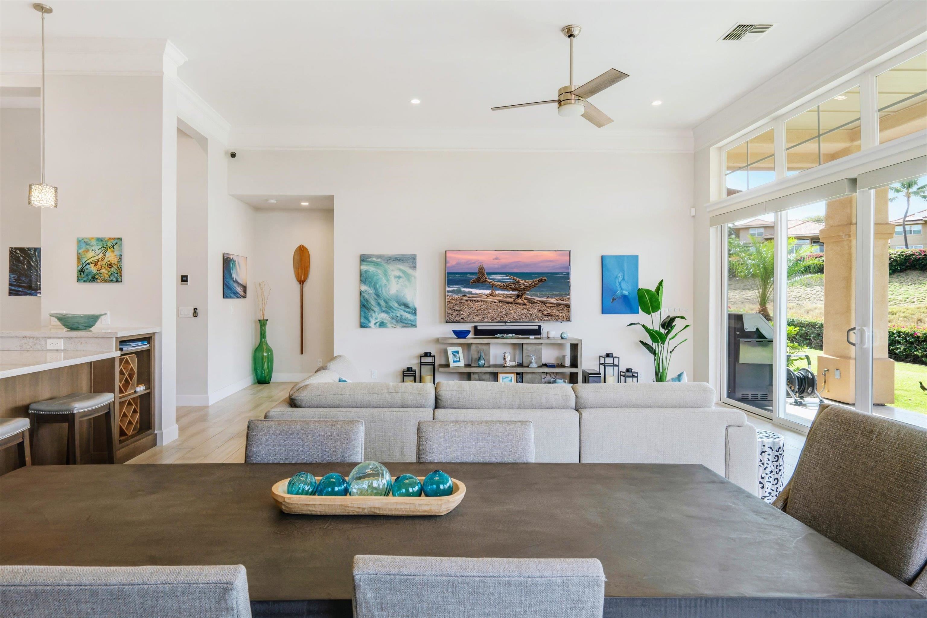1323 Umeke Circle, Unit 102 Kihei, HI 96753 - Photo 17 of 50 a living room with furniture a fireplace and a flat screen tv