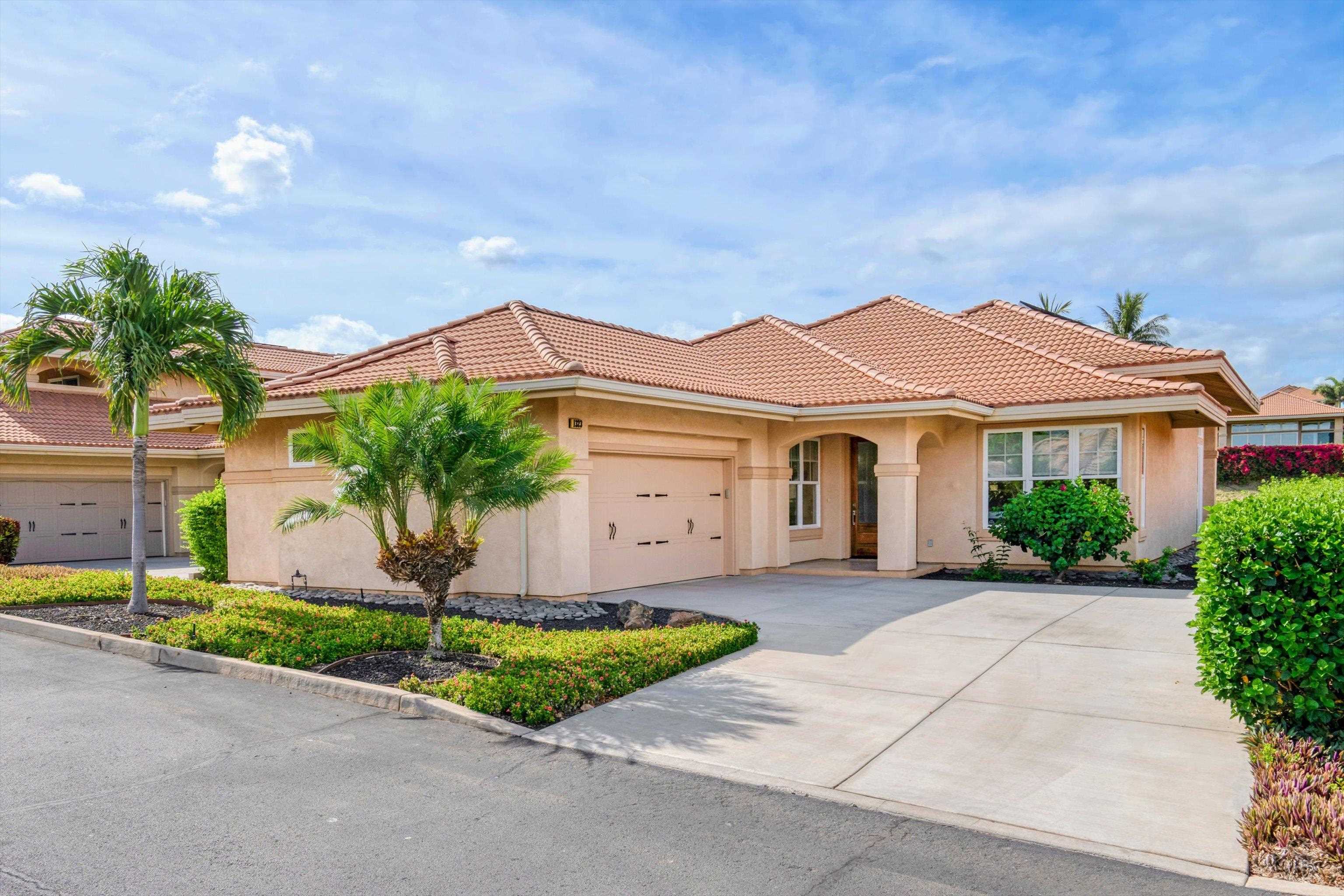1323 Umeke Circle, Unit 102 Kihei, HI 96753 - Photo 19 of 50 a front view of a house with a yard and garage