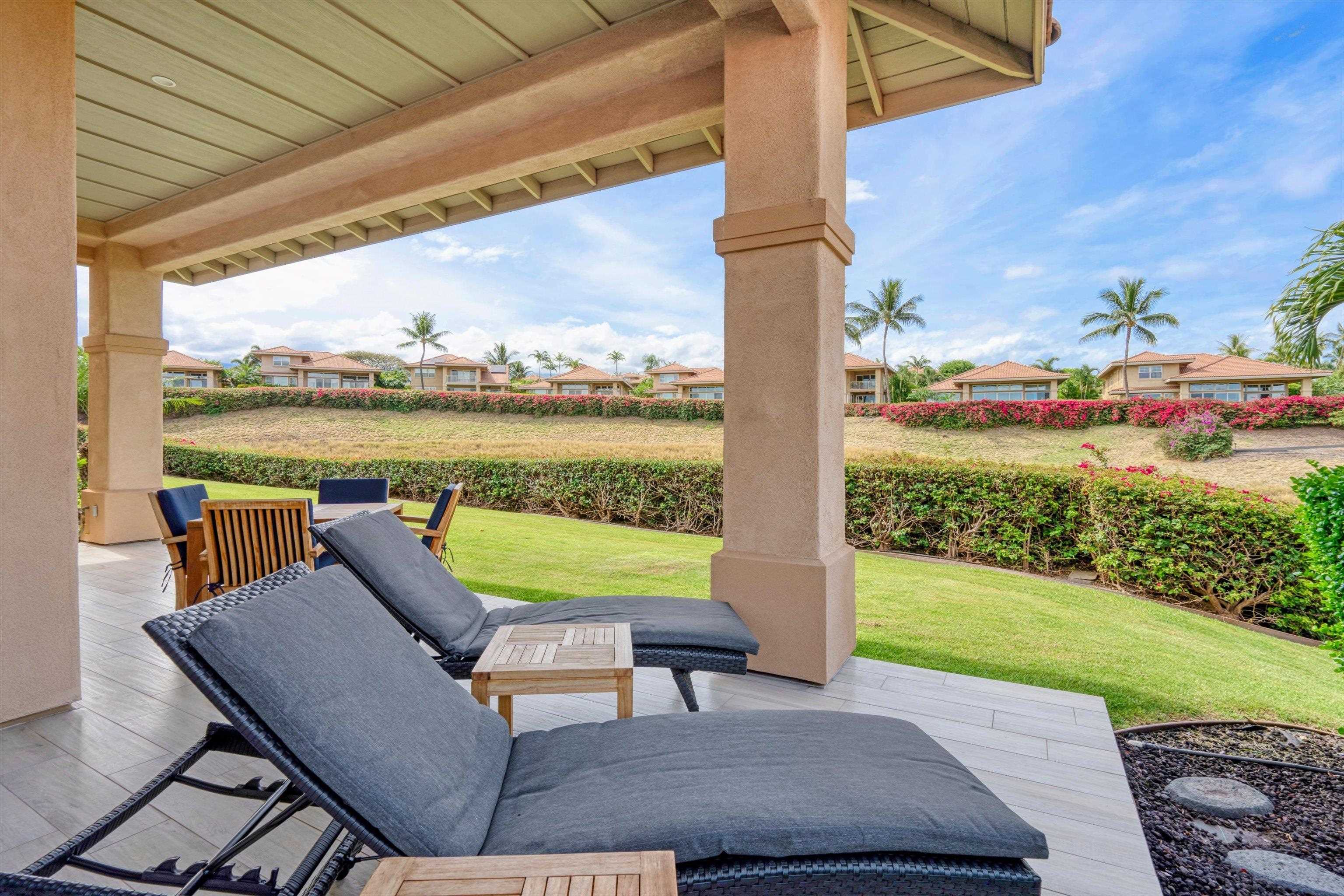 1323 Umeke Circle, Unit 102 Kihei, HI 96753 - Photo 21 of 50 a view of a patio with lawn chairs floor to ceiling window and yard