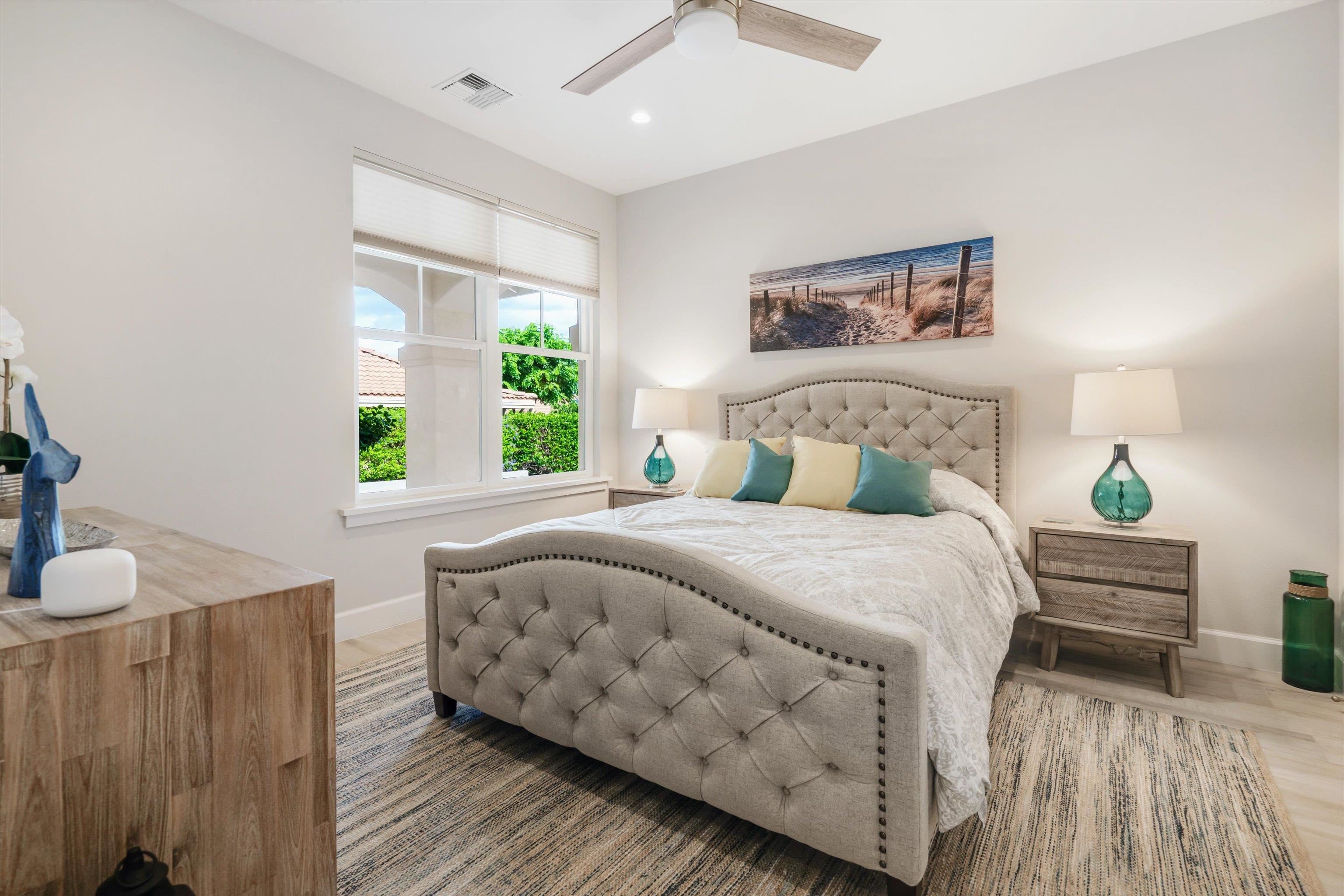 1323 Umeke Circle, Unit 102 Kihei, HI 96753 - Photo 26 of 50 a bedroom with bed and wooden floor