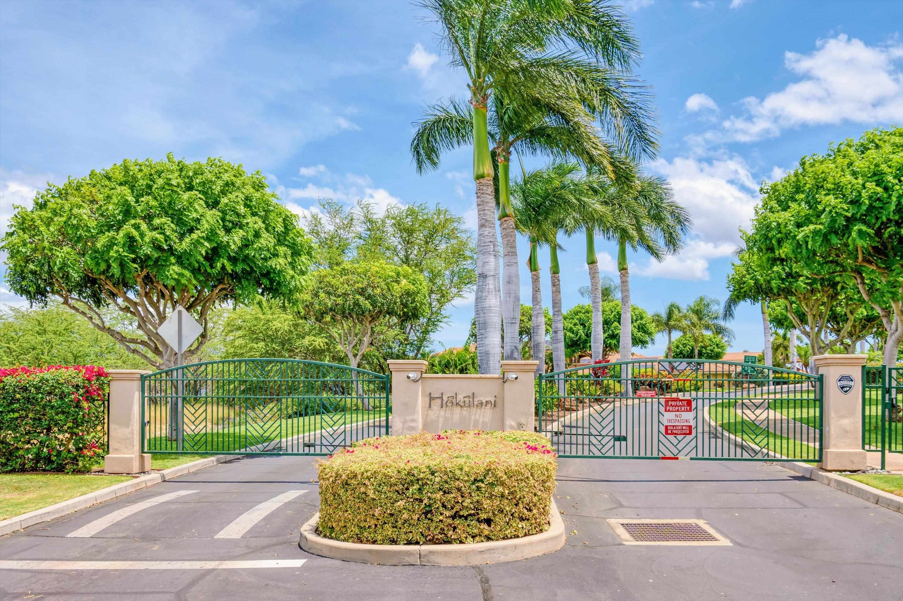 1323 Umeke Circle, Unit 102 Kihei, HI 96753 - Photo 33 of 50 a view of a backyard with a fountain plants and large tree