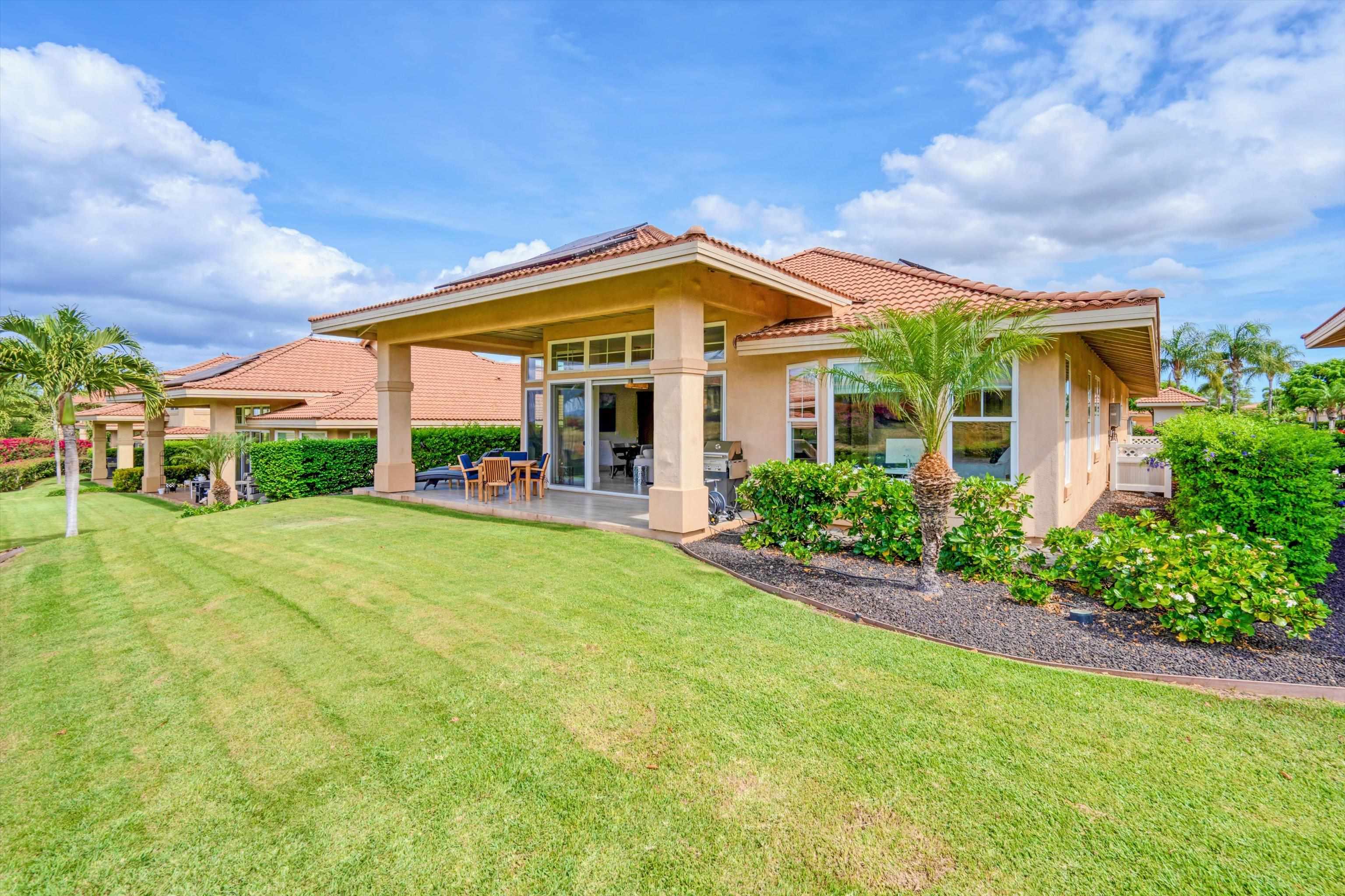 1323 Umeke Circle, Unit 102 Kihei, HI 96753 - Photo 34 of 50 a view of a white house with a big yard and potted plants