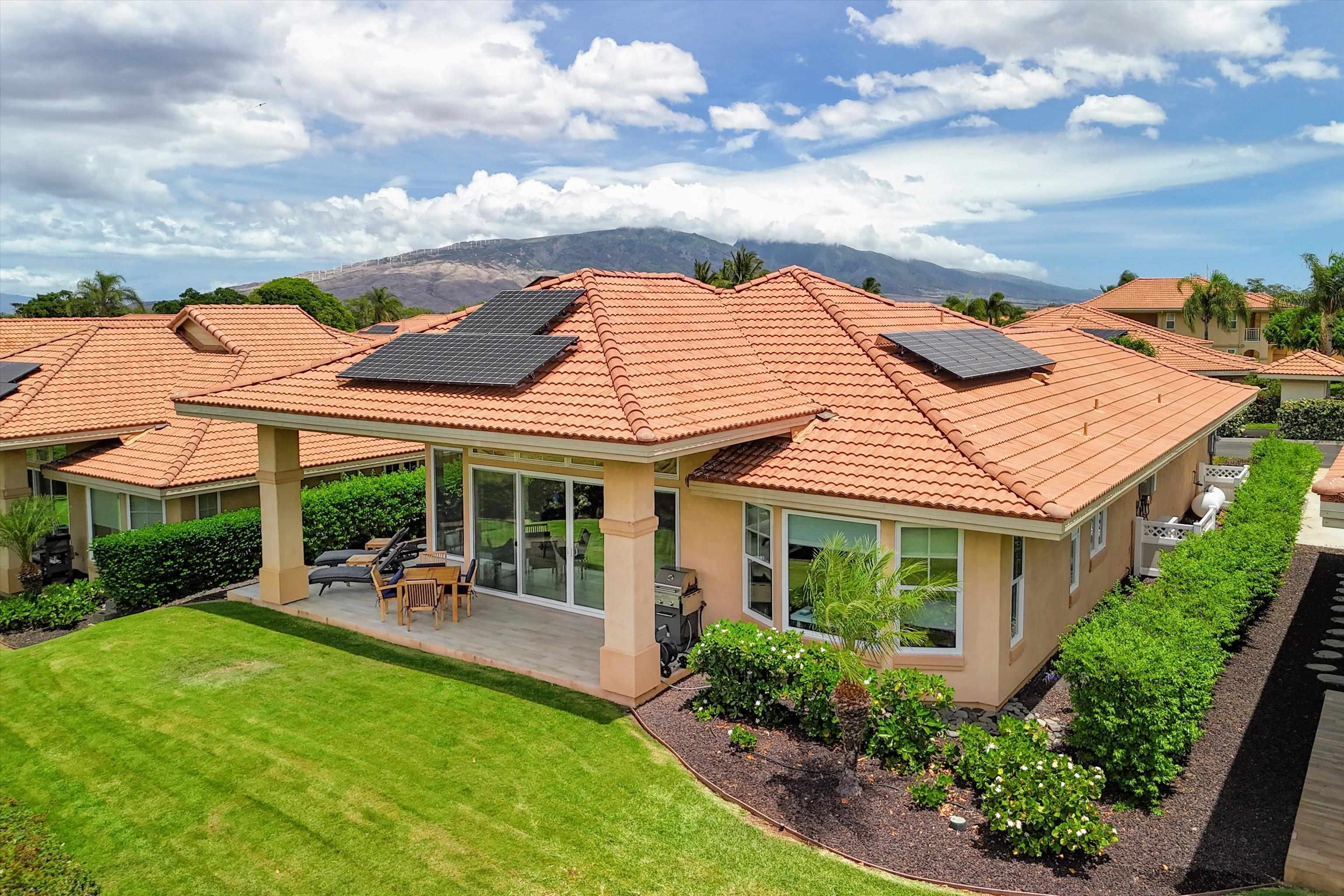1323 Umeke Circle, Unit 102 Kihei, HI 96753 - Photo 36 of 50 a front view of a house with a garden and outdoor seating