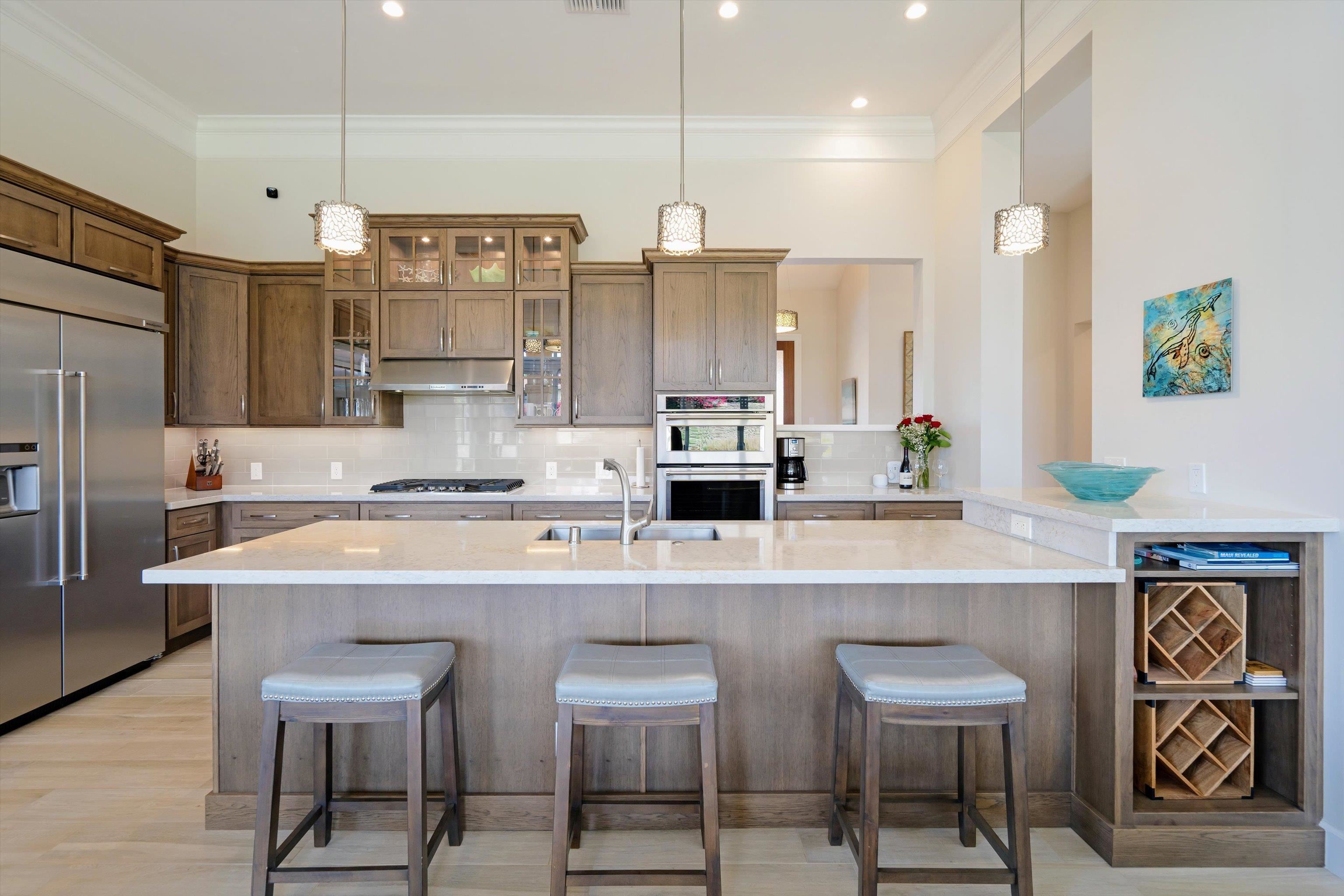 1323 Umeke Circle, Unit 102 Kihei, HI 96753 - Photo 8 of 50 a kitchen with stainless steel appliances granite countertop a sink and a refrigerator