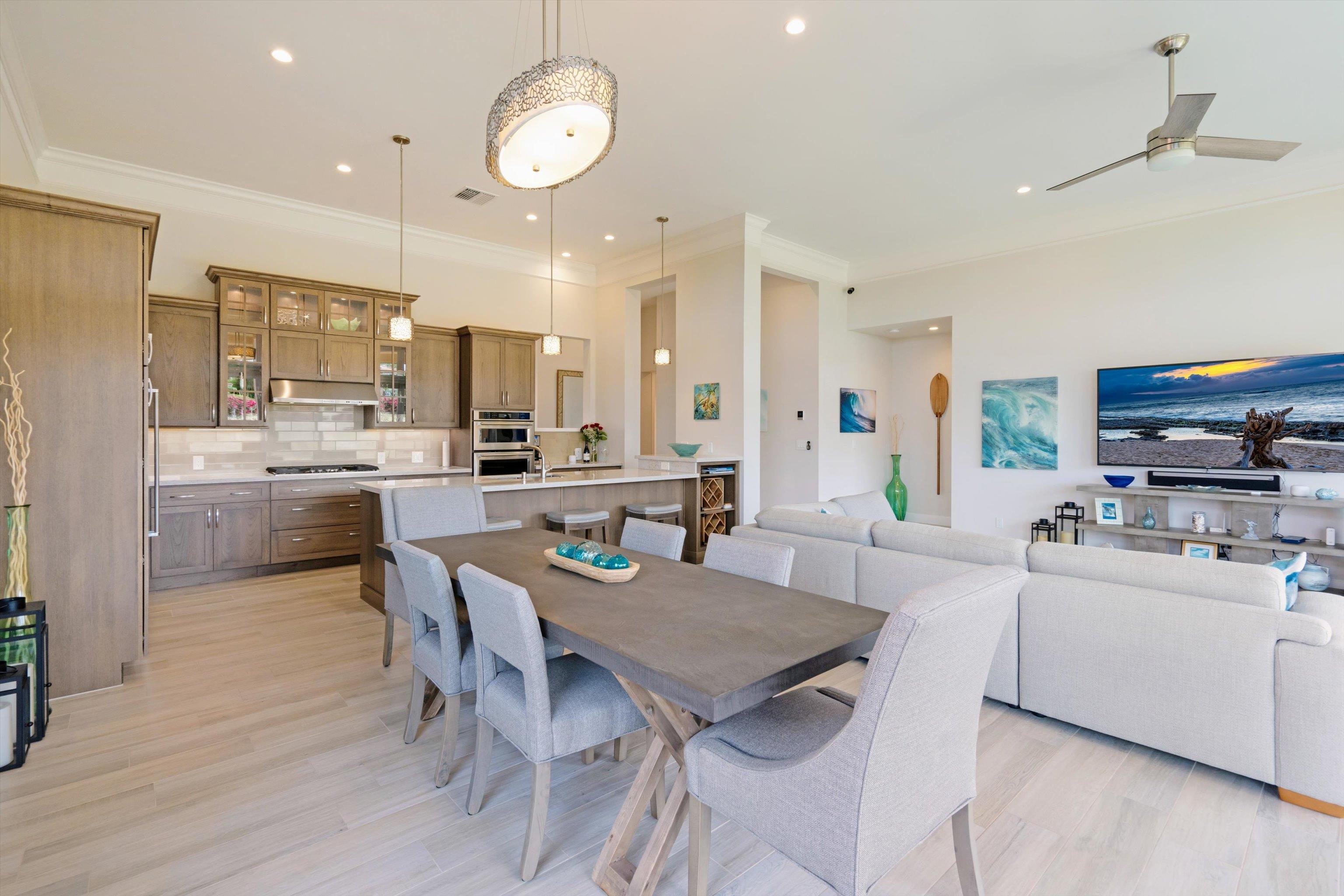 1323 Umeke Circle, Unit 102 Kihei, HI 96753 - Photo 9 of 50 a large kitchen with a table and chairs