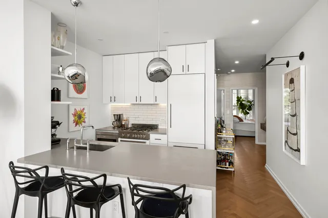 a living room with furniture and kitchen view