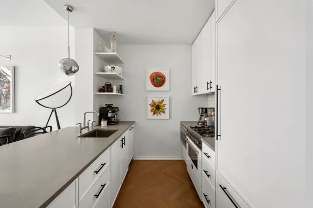 a kitchen with a sink and white cabinets