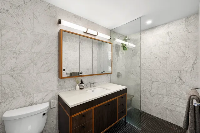 a bathroom with a sink toilet and shower